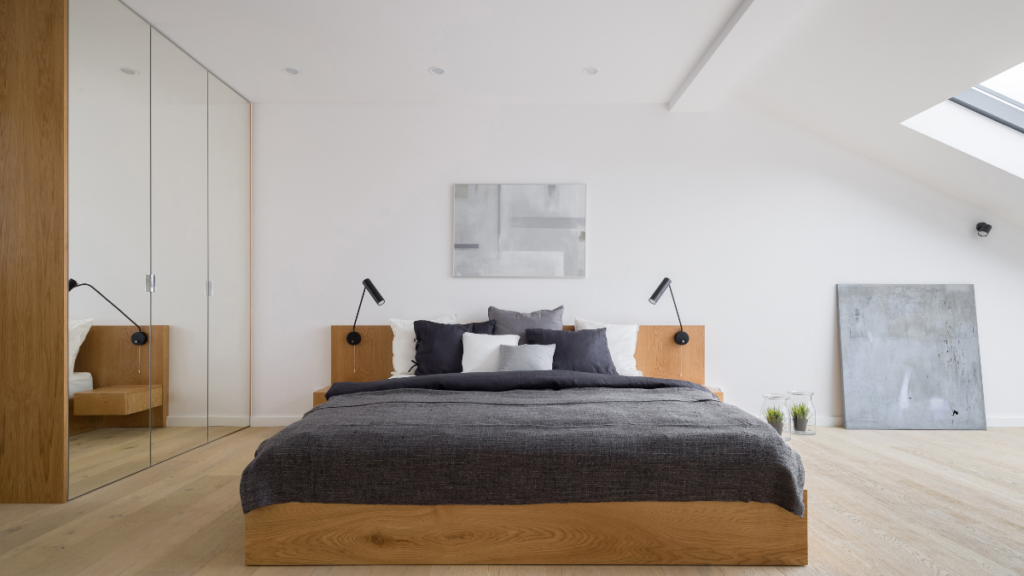 Nowoczesna sypialnia na poddaszu z jasnymi ścianami i drewnianym łóżkiem